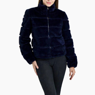 Navy blue faux fur jacket worn by a person on a white background